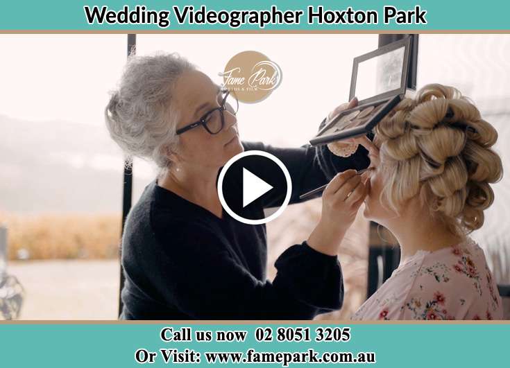 A woman applying makeup to the Bride's face Hoxton Park NSW 2171