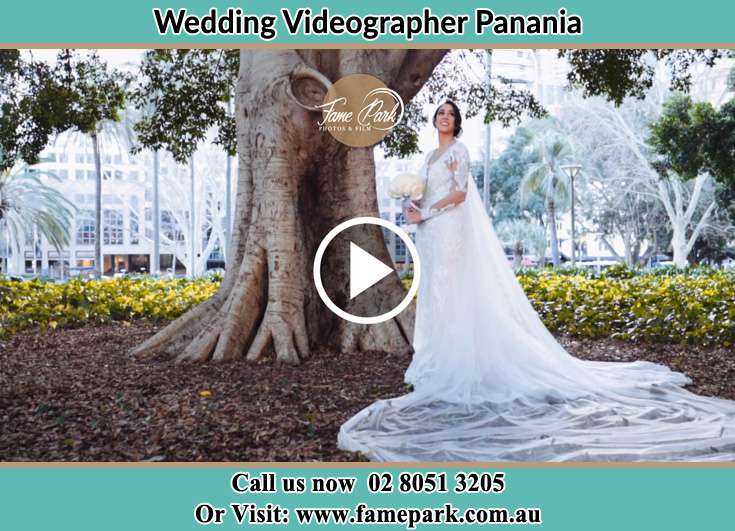 Bride holding a bouquet of flowers under the tree Panania NSW 2213